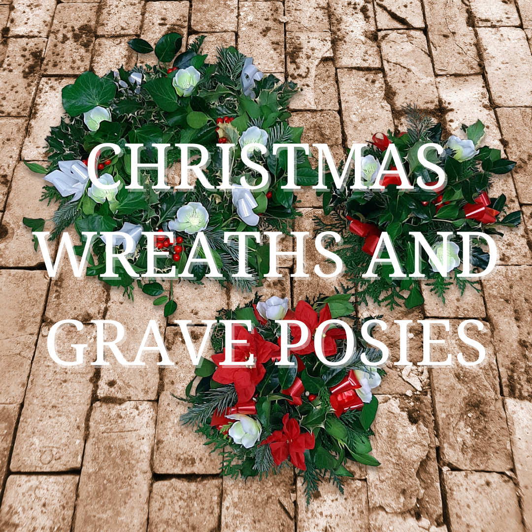 Christmas wreath and grave posy with lush green leaves, white and red flowers, and berries